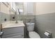 Bathroom showcasing sink, toilet, mirror, and tiled walls at 558 Juniper Dr., Myrtle Beach, SC 29577