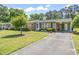 Charming single-story home with a brick and green exterior, carport, and well-maintained landscaping at 558 Juniper Dr., Myrtle Beach, SC 29577
