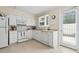Bright kitchen with white cabinets, appliances, and a window at 558 Juniper Dr., Myrtle Beach, SC 29577