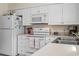Close-up of the kitchen with white cabinets and appliances at 558 Juniper Dr., Myrtle Beach, SC 29577