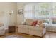 Living room showing a beige sofa and hardwood floors and a bright window at 558 Juniper Dr., Myrtle Beach, SC 29577