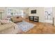 Cozy living room featuring hardwood floors, a large window, and comfortable seating arrangements at 558 Juniper Dr., Myrtle Beach, SC 29577