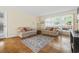 Comfortable living room with parquet floors, neutral couches, and natural light at 558 Juniper Dr., Myrtle Beach, SC 29577