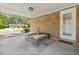 Covered patio with brick wall, concrete flooring, and a cozy seating area at 558 Juniper Dr., Myrtle Beach, SC 29577