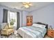 Cozy bedroom with a ceiling fan, a window, a bed, and a cabinet at 5813 Mossy Oaks Dr., North Myrtle Beach, SC 29582
