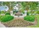 Elegant community entrance with brick pillars, a landscaped sign, and mature trees, offering a welcoming ambiance at 5813 Mossy Oaks Dr., North Myrtle Beach, SC 29582