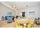 Inviting dining room with wood table, chairs, ceiling fan, and views into the living area at 5813 Mossy Oaks Dr., North Myrtle Beach, SC 29582