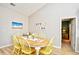 Bright dining area with table, and six yellow chairs at 5813 Mossy Oaks Dr., North Myrtle Beach, SC 29582