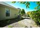 Side exterior with well-maintained landscaping, including trees and bushes, provides a private outdoor space at 5813 Mossy Oaks Dr., North Myrtle Beach, SC 29582
