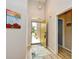 Bright foyer featuring an open doorway, neutral walls, high ceilings, and wood look flooring at 5813 Mossy Oaks Dr., North Myrtle Beach, SC 29582