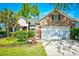 Beautiful home with brick facade, manicured lawn, flower beds, and a two-car garage at 5813 Mossy Oaks Dr., North Myrtle Beach, SC 29582