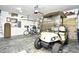 View of garage with golf cart parked in front of well organized storage along the walls at 5813 Mossy Oaks Dr., North Myrtle Beach, SC 29582