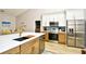 Kitchen featuring stainless appliances, white cabinetry, quartz countertops, and undermount sink at 5813 Mossy Oaks Dr., North Myrtle Beach, SC 29582