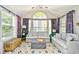 The living room has cathedral ceilings and many windows providing lots of natural light at 5813 Mossy Oaks Dr., North Myrtle Beach, SC 29582