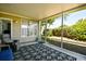 Inviting screened porch with decorative rug, comfortable seating, and views of the lush, green backyard at 5813 Mossy Oaks Dr., North Myrtle Beach, SC 29582