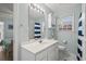 Well-lit bathroom with a vanity, storage cabinet, and bathtub with shower at 6001 - 1433A S Kings Hwy., Myrtle Beach, SC 29575