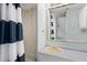 Compact bathroom features a stand-up shower with navy curtain and a neutral vanity at 6001 - 1433A S Kings Hwy., Myrtle Beach, SC 29575