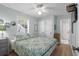 Comfortable bedroom with a large window, ceiling fan, and stylish decor at 6001 - 1433A S Kings Hwy., Myrtle Beach, SC 29575
