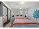 Cozy bedroom featuring light blue walls, a ceiling fan, and a comfortable bed with vibrant bedding at 6001 - 1433A S Kings Hwy., Myrtle Beach, SC 29575