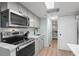 Modern kitchen with stainless steel appliances, stone countertops, and light colored cabinetry at 6001 - 1433A S Kings Hwy., Myrtle Beach, SC 29575