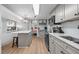 Open kitchen with gray cabinetry, marble countertops, and a view to the living area at 6001 - 1433A S Kings Hwy., Myrtle Beach, SC 29575