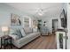 Bright living room with a comfortable gray sofa, coastal decor, and plenty of natural light at 6001 - 1433A S Kings Hwy., Myrtle Beach, SC 29575