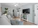 Cozy living room featuring a gray sofa, coastal decor, and easy access to the kitchen and outdoor spaces at 6001 - 1433A S Kings Hwy., Myrtle Beach, SC 29575