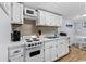Well-lit kitchen featuring white cabinets, countertops, and modern appliances at 6001- 1771 S Kings Highway, Myrtle Beach, SC 29575