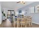 Open-concept dining area with seating for six and views of the living area and balcony at 6001 N Ocean Blvd. # 240, North Myrtle Beach, SC 29582