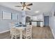 Dining area next to the kitchen with a white dining table, seating for six, and modern lighting at 6001 N Ocean Blvd. # 240, North Myrtle Beach, SC 29582