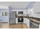 Updated kitchen featuring stainless steel appliances, white cabinets, and granite countertops at 6001 N Ocean Blvd. # 240, North Myrtle Beach, SC 29582