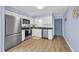 Galley kitchen with stainless steel appliances, white cabinets, and modern fixtures at 6001 N Ocean Blvd. # 240, North Myrtle Beach, SC 29582