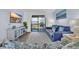 Cozy living room showcasing a large sofa and sliding glass doors leading to a balcony at 6001 N Ocean Blvd. # 240, North Myrtle Beach, SC 29582