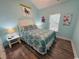 Bedroom with a queen bed with teal bedding, and luxury vinyl plank flooring at 6001 - Z47 S Kings Hwy., Myrtle Beach, SC 29575
