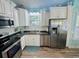 Bright kitchen features stainless steel appliances and white cabinetry at 6001 - Z47 S Kings Hwy., Myrtle Beach, SC 29575