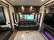 This travel trailer living room has leather seating, a fireplace, and a TV, perfect for relaxing and entertaining at 6001-N53 S Kings Hwy., Myrtle Beach, SC 29575