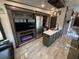 This travel trailer living room and kitchen have a fireplace, stainless appliances, and a central island at 6001-N53 S Kings Hwy., Myrtle Beach, SC 29575