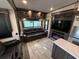 This travel trailer living room has leather seating, a fireplace, and a TV, perfect for relaxing and entertaining at 6001-N53 S Kings Hwy., Myrtle Beach, SC 29575