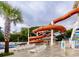 Serene pool area featuring an orange waterslide, lounge chairs, and manicured landscaping at 6001-N53 S Kings Hwy., Myrtle Beach, SC 29575