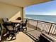 Outdoor dining on balcony with ocean views at 603 S Ocean Blvd. # 912, North Myrtle Beach, SC 29582