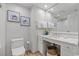 Elegant bathroom featuring a toilet, sink, and artistic wall décor at 603 S Ocean Blvd. # 912, North Myrtle Beach, SC 29582