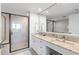 This contemporary bathroom features a large shower, a double sink, and plenty of counter space at 603 S Ocean Blvd. # 912, North Myrtle Beach, SC 29582