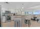 Bright, open kitchen features stainless steel appliances, granite countertops and breakfast bar that open to the dining area at 603 S Ocean Blvd. # 912, North Myrtle Beach, SC 29582