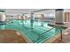 Indoor pool with bright blue water, tile columns, and a sun deck with lounge chairs at 603 S Ocean Blvd. # 912, North Myrtle Beach, SC 29582