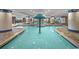 Indoor pool area with unique center water feature, tiled columns, and ample lounge seating at 603 S Ocean Blvd. # 912, North Myrtle Beach, SC 29582