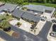 Aerial view of a property showcasing its landscaped yard, concrete driveway, golf cart, and proximity to neighboring homes at 634 Cypress Ln., North Myrtle Beach, SC 29582
