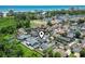 Aerial view pinpointing the property's location within a community, near lush greenery and a glimpse of the ocean at 634 Cypress Ln., North Myrtle Beach, SC 29582