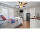 Comfortable bedroom with hardwood floors, ceiling fan, and adjacent bathroom at 634 Cypress Ln., North Myrtle Beach, SC 29582