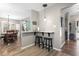 View of the dining area and bar seating featuring black bar stools and wood floors at 634 Cypress Ln., North Myrtle Beach, SC 29582