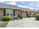 Charming home featuring a landscaped front yard, a small patio set, and well-maintained exterior, perfect for curb appeal at 634 Cypress Ln., North Myrtle Beach, SC 29582